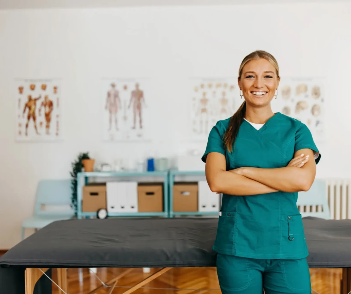 Smiling medical professional in green scrubs