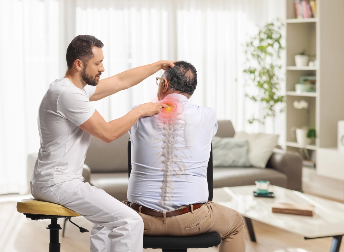 Therapist adjusting client's spine in clinic