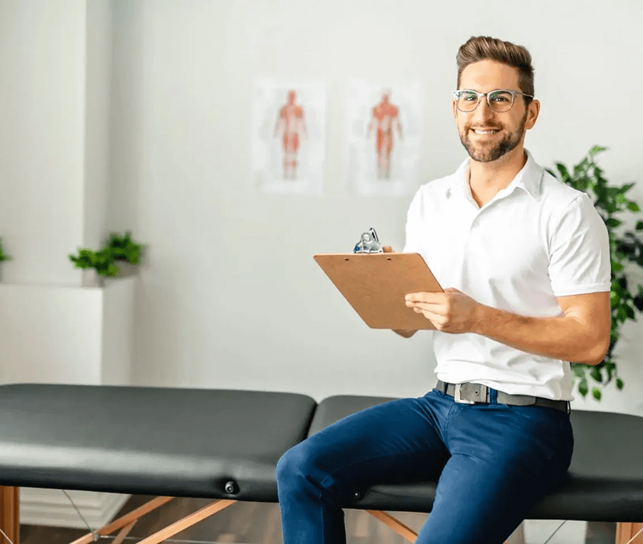 Man holding clipboard in therapy room